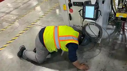 Industrial technician monitoring automated machinery in production area